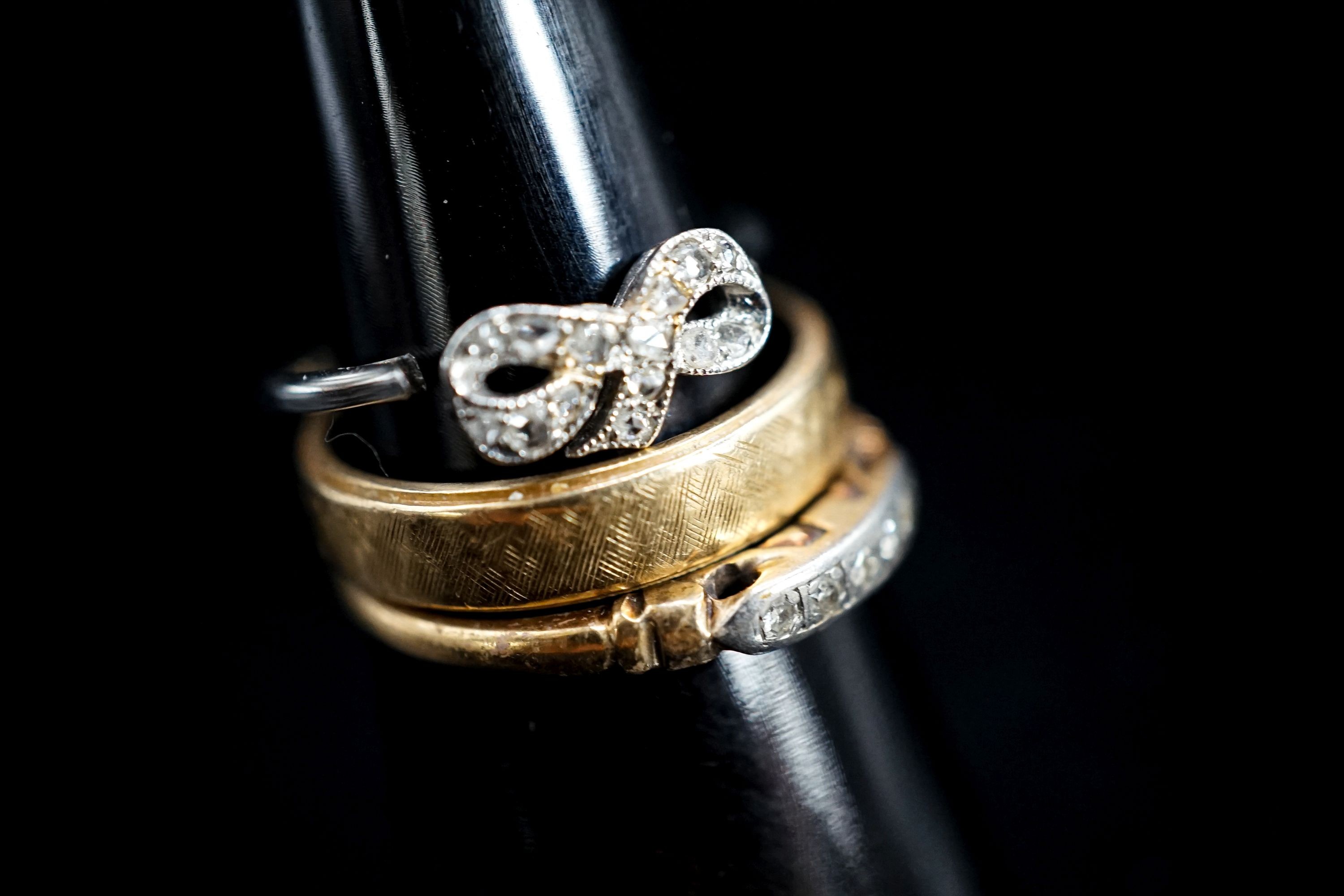 A 14k yellow metal band and two other diamond set rings, one stamped 14k, gross weight 7.5 grams.